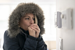 Woman With Warm Clothing Feeling The Cold Inside House